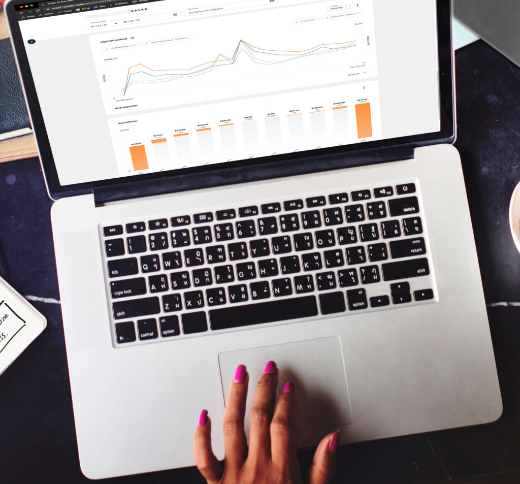 Person working on laptop with Scout software displayed on the screen