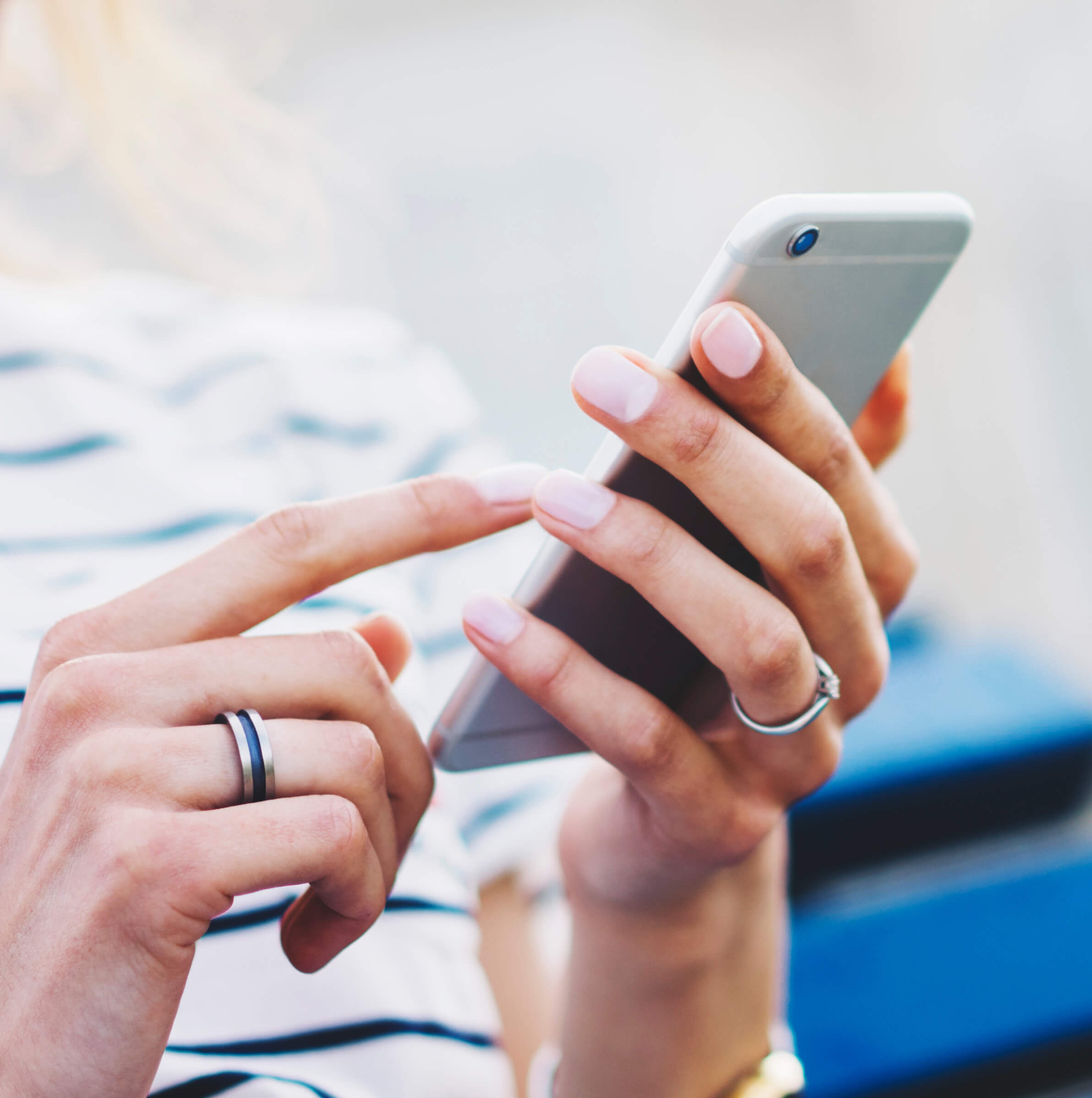 Stock image of a woman holding a smartphone