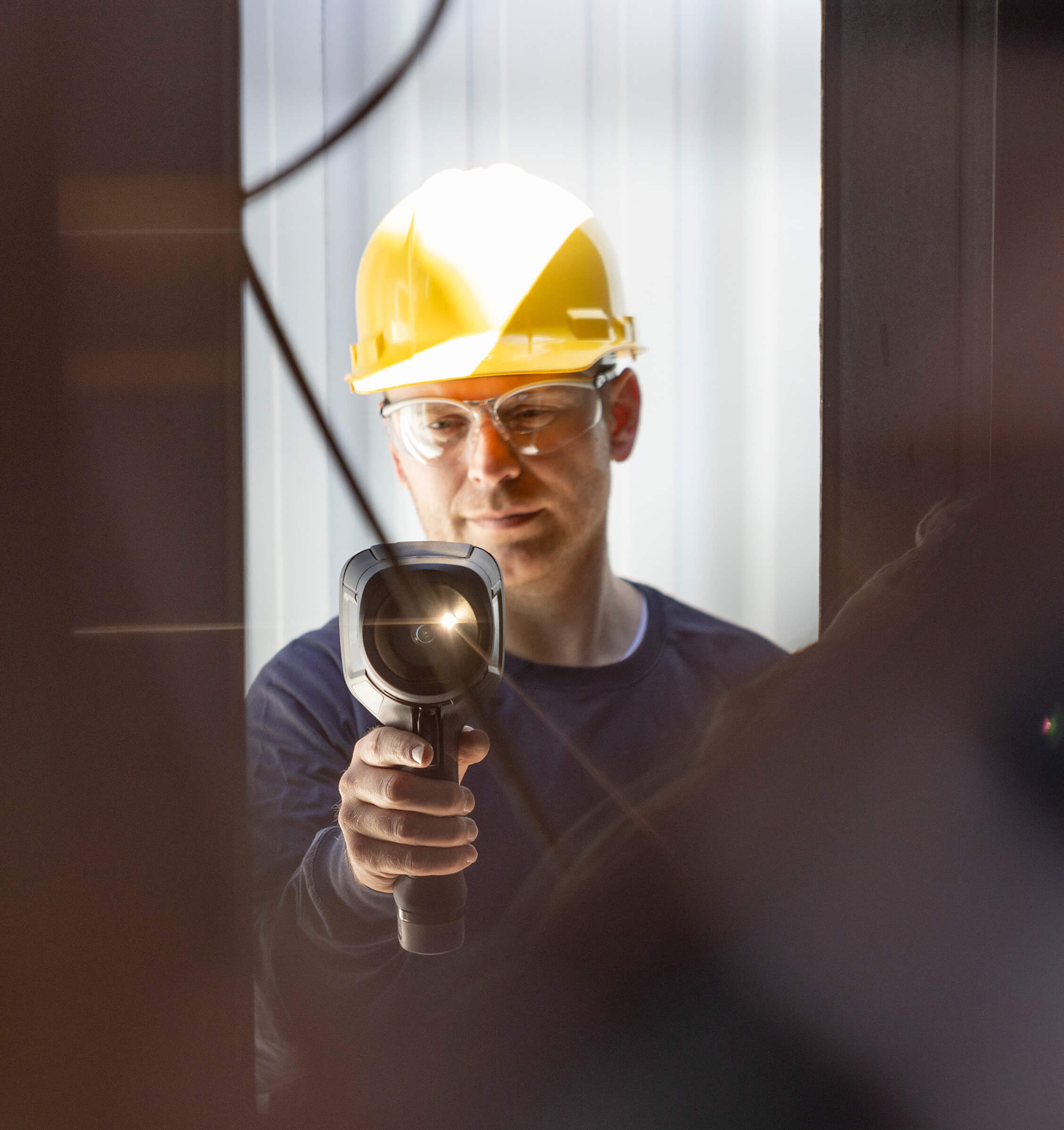 Man holding up a FLIR thermal imaging camera