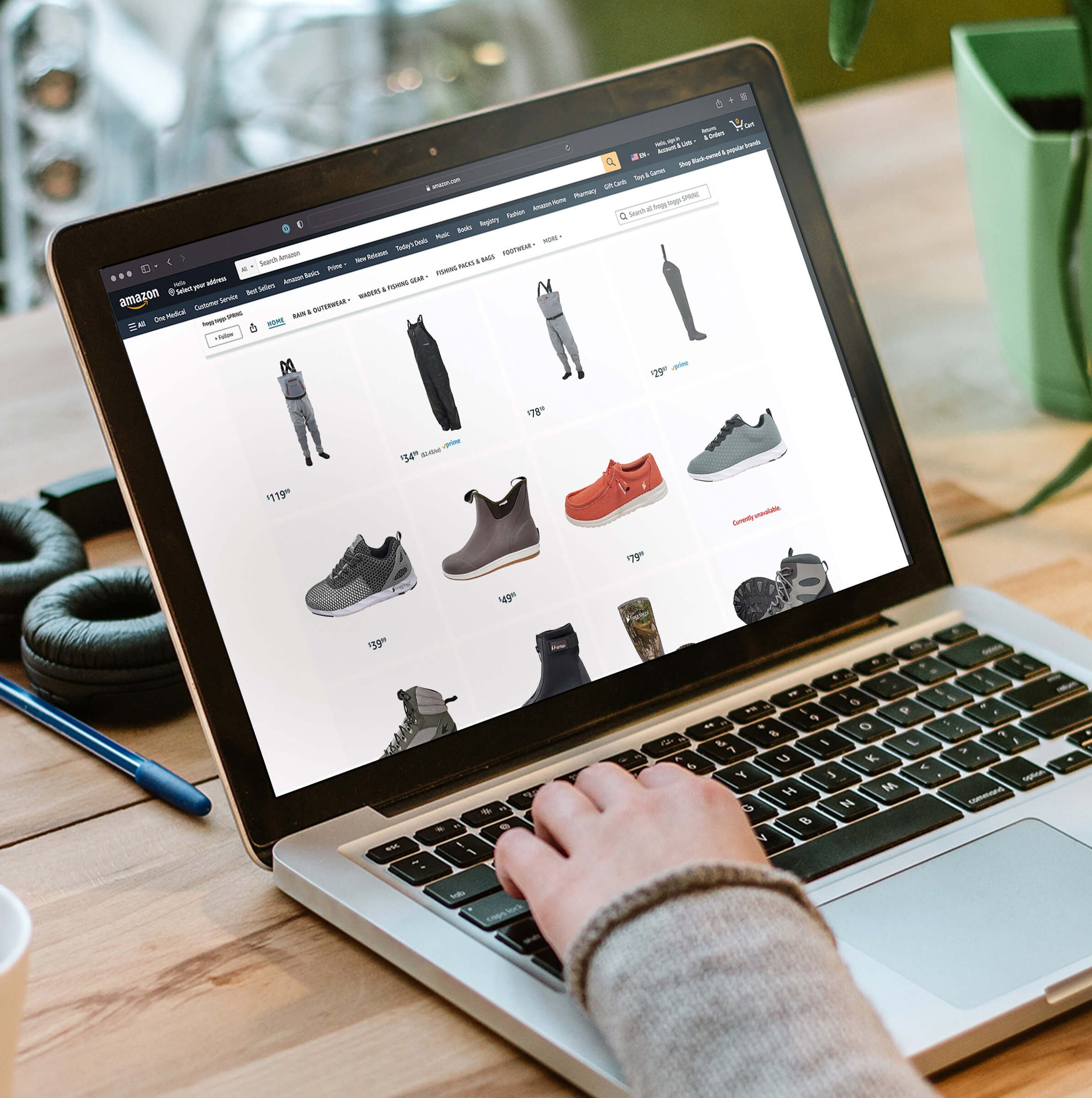 Person shopping on a laptop with Frogg Toggs products displayed on the screen
