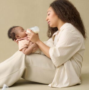 Woman holding a baby and bottle feeding them